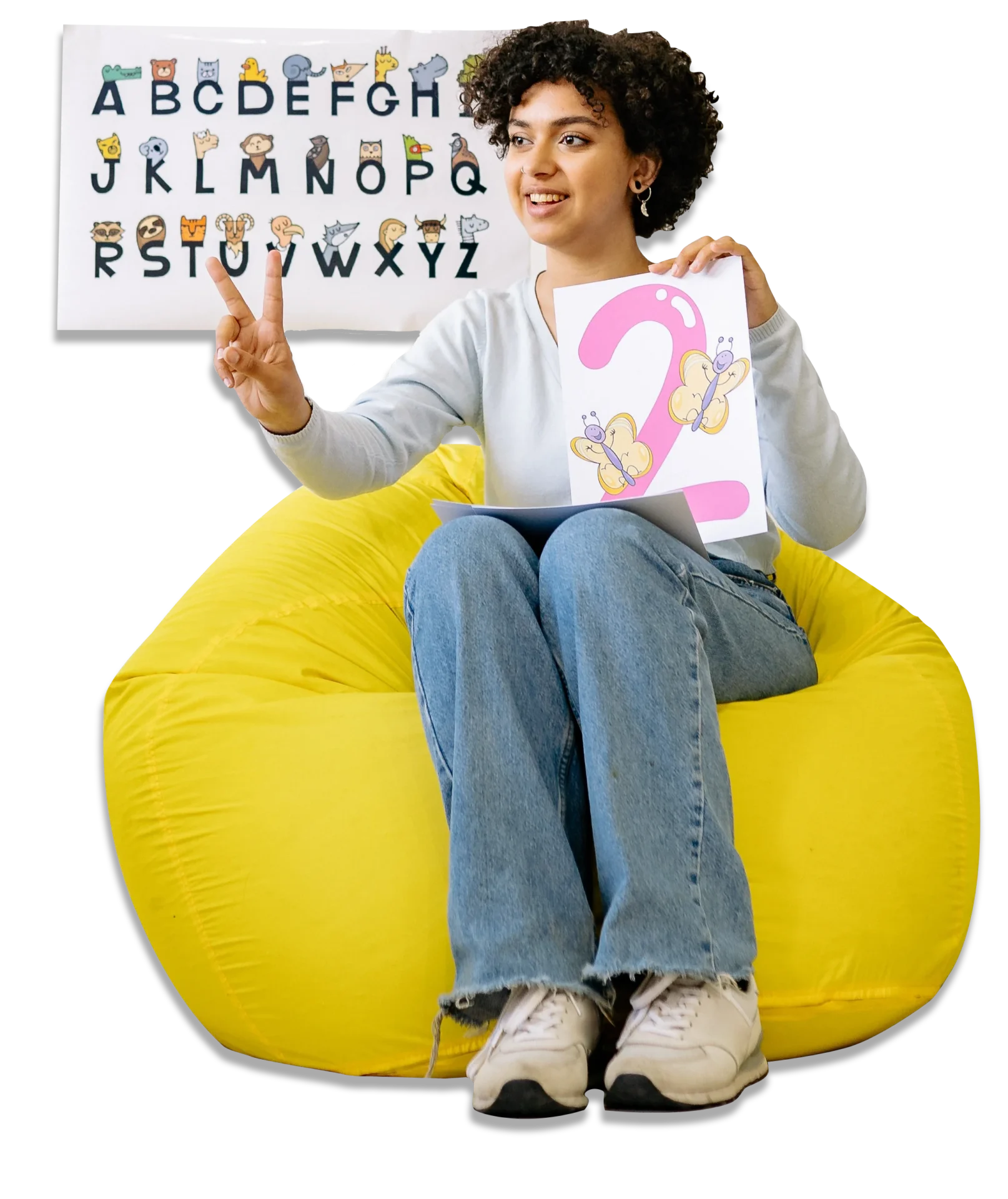 A woman sitting on top of a yellow bean bag chair.