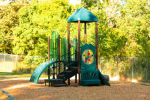 A playground with many different colored slides.